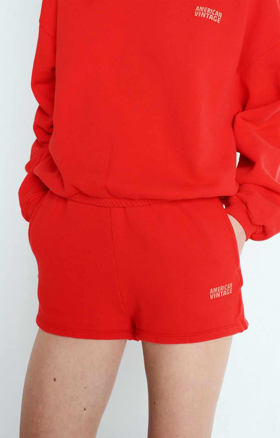 Close-up of cotton fabric texture and logo detail on American Vintage G-IZU09A shorts in Vintage Strawberry, sold at MEZI Australia.