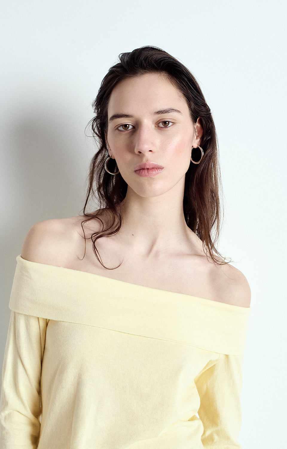 Front view of American Vintage G-OUK02B off-shoulder long-sleeve top in yellow, soft cotton, available at MEZI Australia.