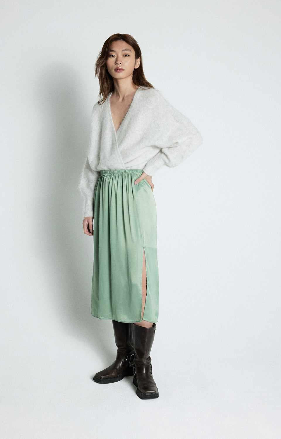 Model wearing American Vintage sage maxi skirt G-UNY13B, side profile showing flowing drape.