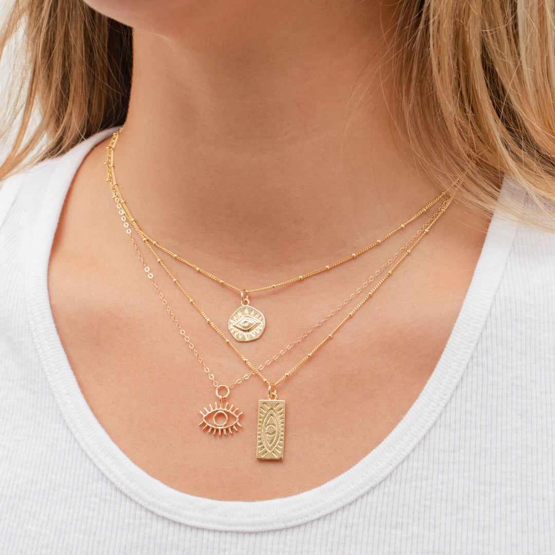 Evil eye gold disc pendant